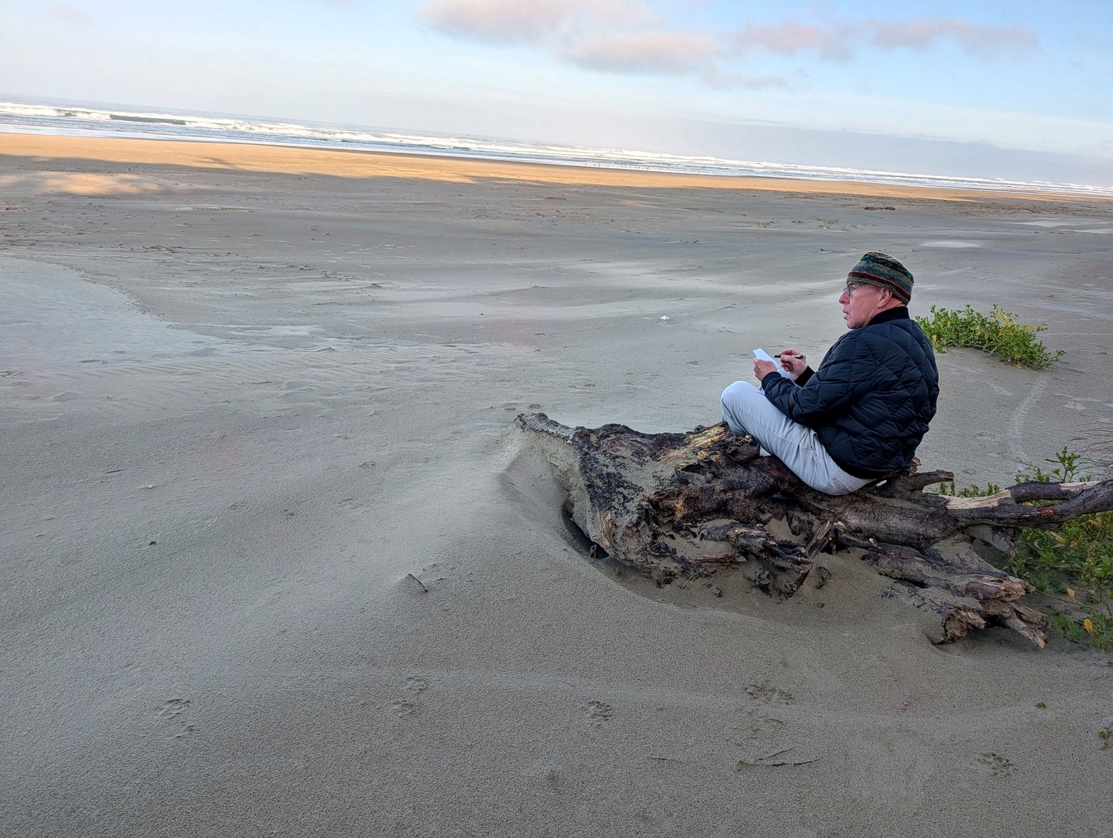 Richard taking field notes on the Oregon coast, sketchbook in hand